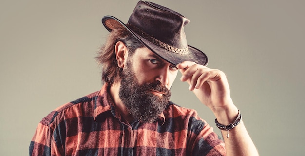 Man unshaven cowboys American cowboy Leather Cowboy Hat Portrait of young man wearing cowboy hat Cowboys in hat Handsome bearded macho