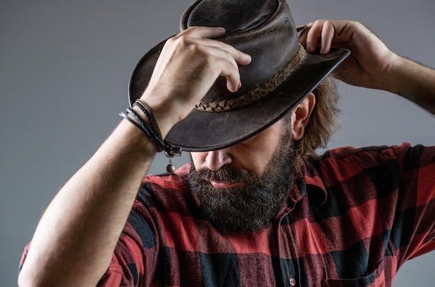 Man unshaven cowboys American cowboy Leather Cowboy Hat Portrait of young man wearing cowboy hat Cowboys in hat Handsome bearded macho