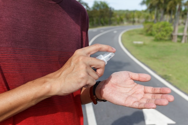 The man use alcohol to clean hands for prevention of coronavirus virus outbreak. COIVD 19