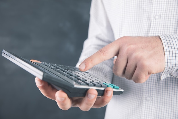 A man uses a calculator .