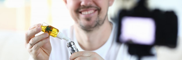 Man uses hemp oil for an electronic cigarette