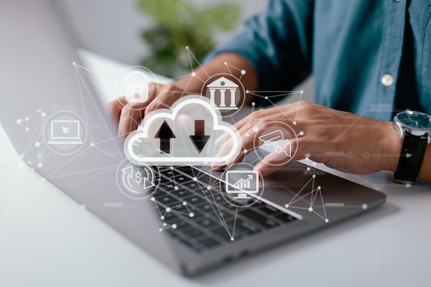 A man uses a laptop with a cloud computing diagram shown on
hand cloud technology data storage networking and internet service
concepts