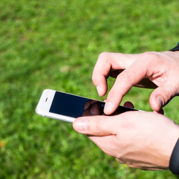 a man uses a smartphone outdoor
