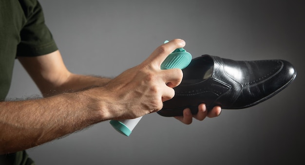 Man using antibacterial spray against unpleasant odors