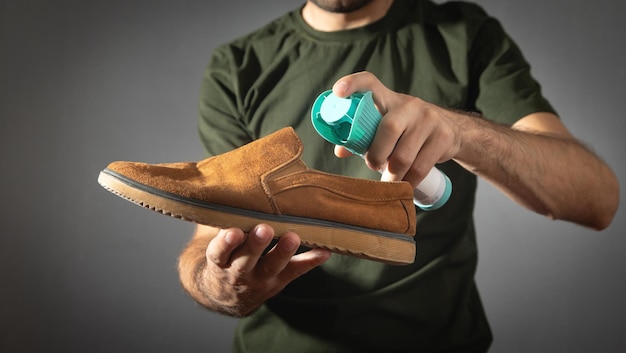 Man using antibacterial spray against unpleasant odors