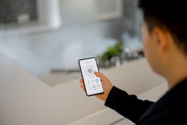 Man using app of smart home on smartphone