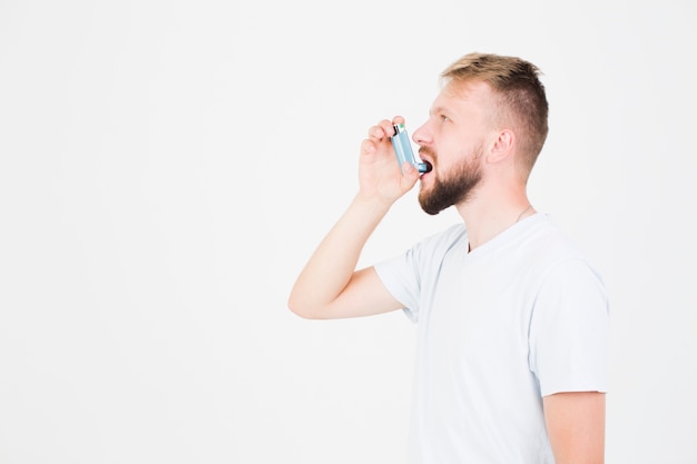 Photo man using asthma inhaler