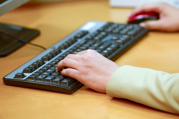 man using a computer on the desk in the workplace