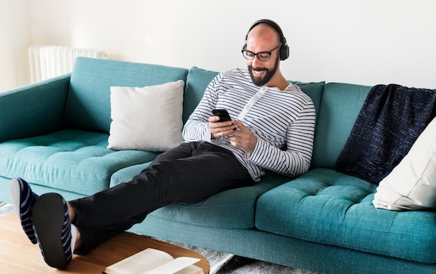 Man using device on couch