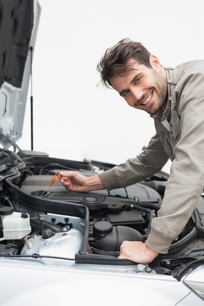 Man using dipstick to check oil