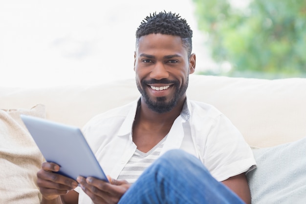 Man using his tablet on couch