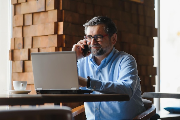 Man using laptop in cafe bar