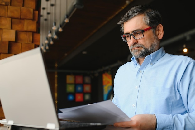 Man using laptop in cafe bar