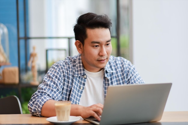 Man using laptop in cafe