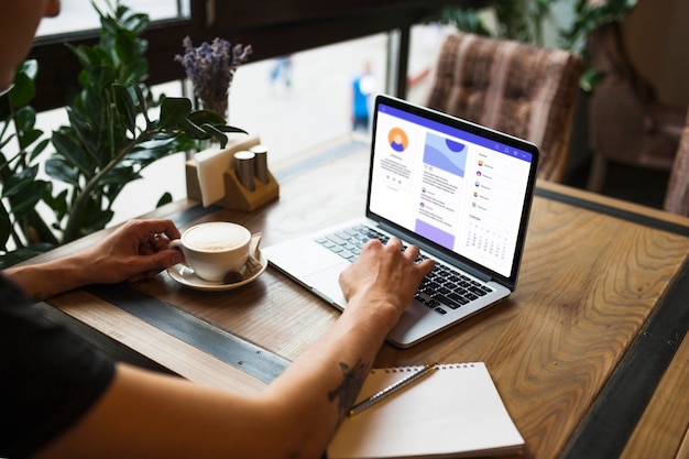 Man using laptop in cafe