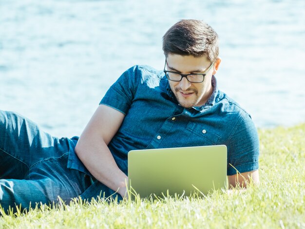 Man using laptop in city park