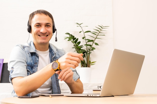 Man Using Laptop On Desk At Home