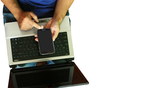 Man using laptop and hand touch screen smart phone.