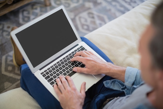 Man using laptop in living room