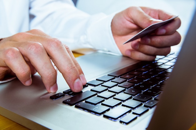 Man using laptop for online shopping