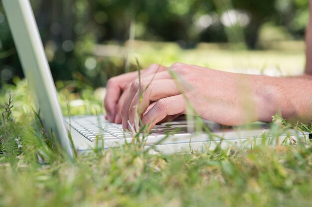 Man using laptop in the park