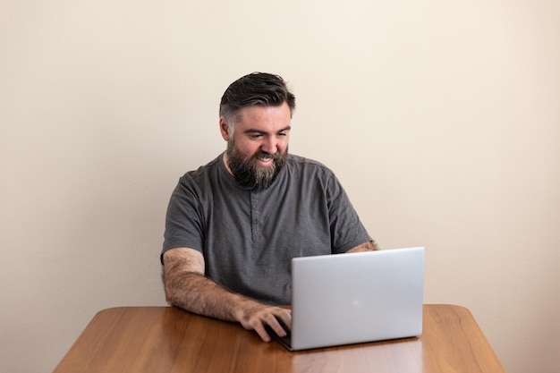 Man using a laptop placed on a table