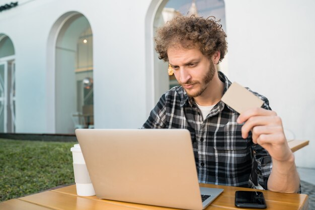 Man using laptop to shop online.