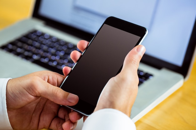 Man using laptop and smartphone