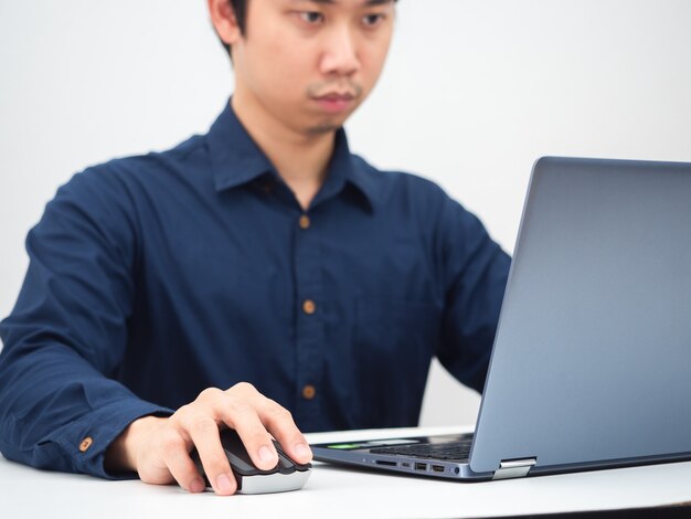 Man using laptop on table crop shotWorking from home concept