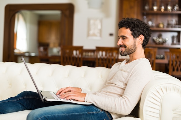 Man using a laptop while sitting on the couch