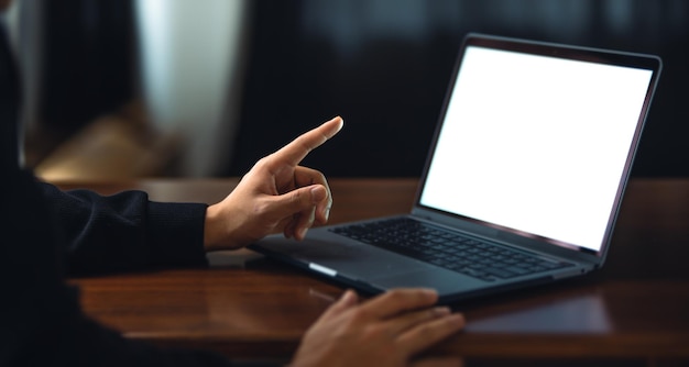 Man using laptop with white blank screen mockup