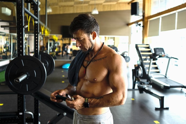 Man using the mobile in a gym