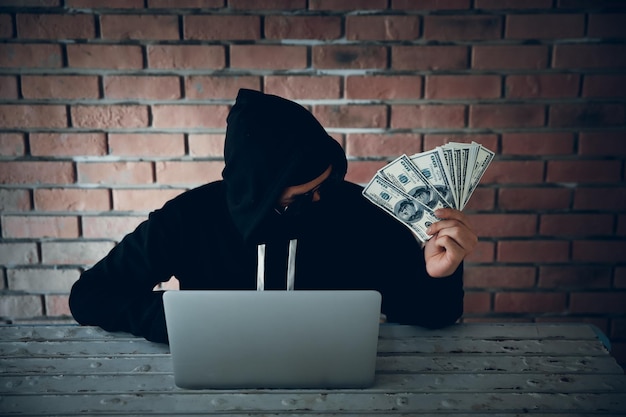 man using mobile phone against brick wall