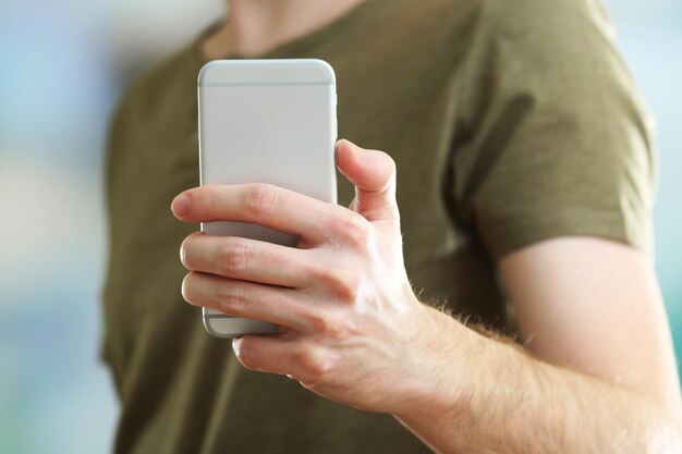 Man using mobile smart phone on bright background