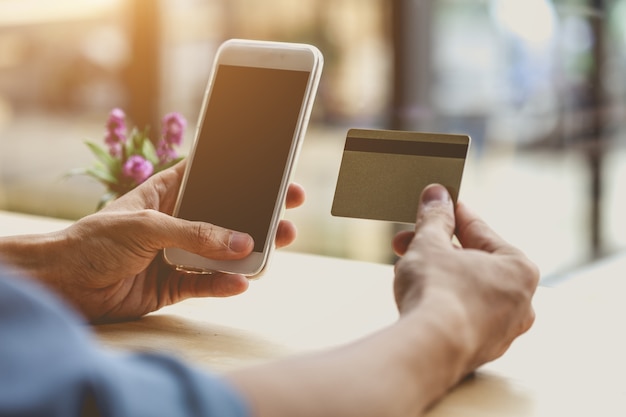 Man using mobile smartphone and credit card