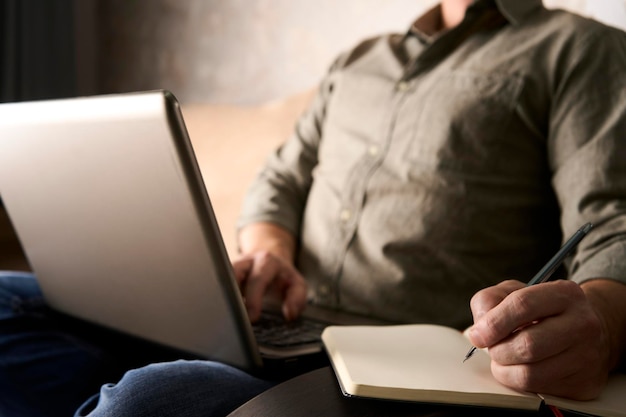 Man using on notebook and working on laptop computer