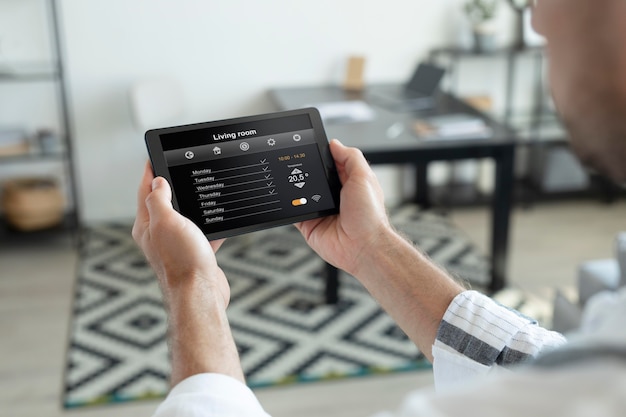 Man using a smart home tablet indoors