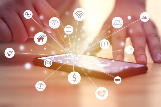 man using smart phone with internet of things graphic icons mobile app wireless technology concept