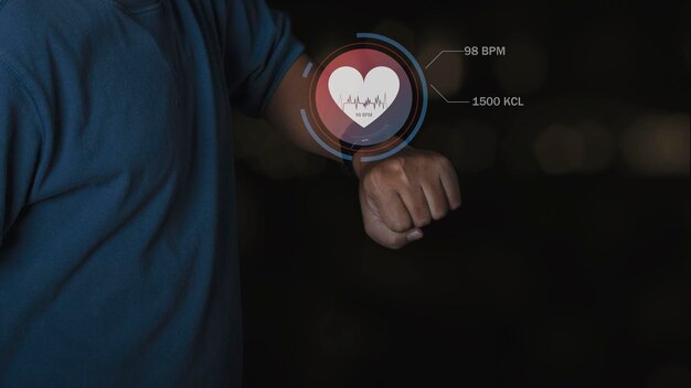 Man using smart watch technology checking heart rate with health app icon on the screen. Holographic icon user interface. Futuristic smart watch technology. Healthcare concept.