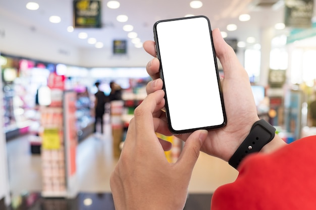 Man using smartphone at abstract blurred street night. Blank screen for graphics display montage.