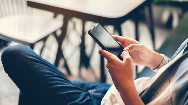 Man using smartphone, During leisure time. 