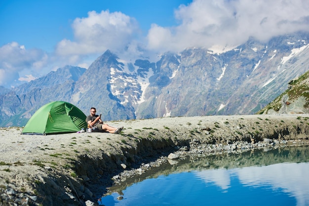 Man using smartphone in mountains