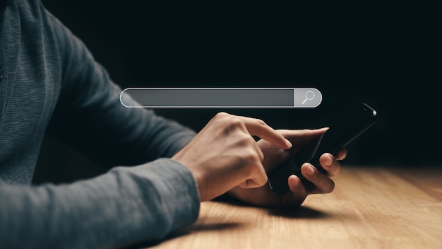 Man using a smartphone to Searching for information with the Search bar, Web browser, Search Engine.