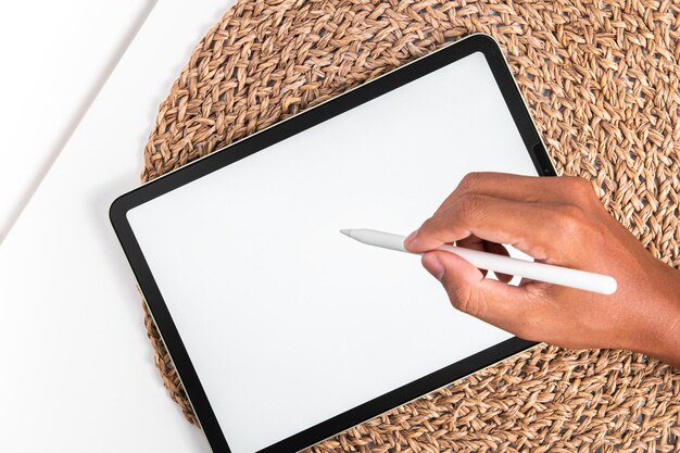 Photo man using tablet computer while sitting on a wooden floor view from above clipping path included