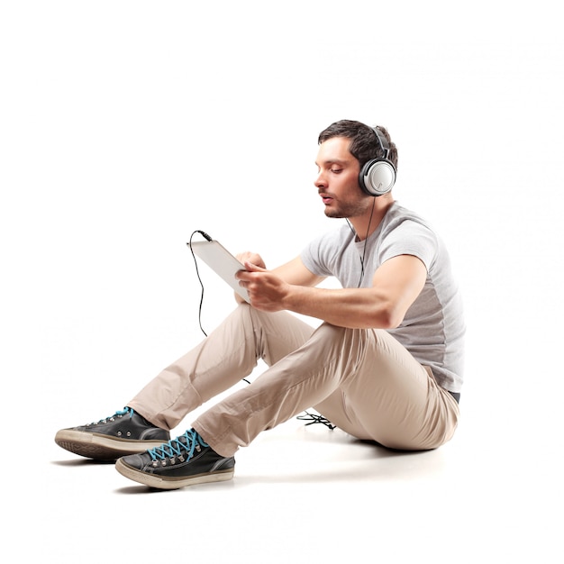 Man using a tablet and headphones