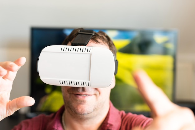 Man using virtual reality simulator at home