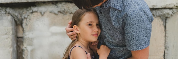 Man vader heeft tijd met kind dochter meisje negen jaar knuffels en strek haar haar gelukkige vader spelen met kind het echte leven authentieke dag van vandaag vaderschap momenten vaderlijke liefde zorg banner