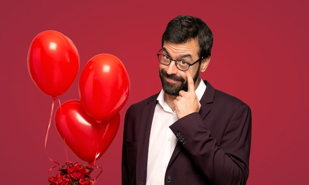 Man in valentine day looking to the front over red background