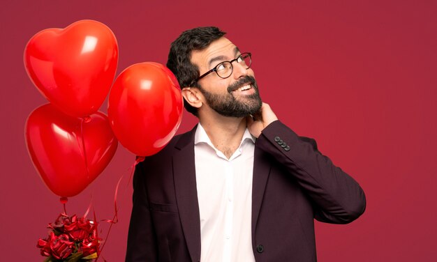 Man in valentine day thinking an idea while scratching head over red background