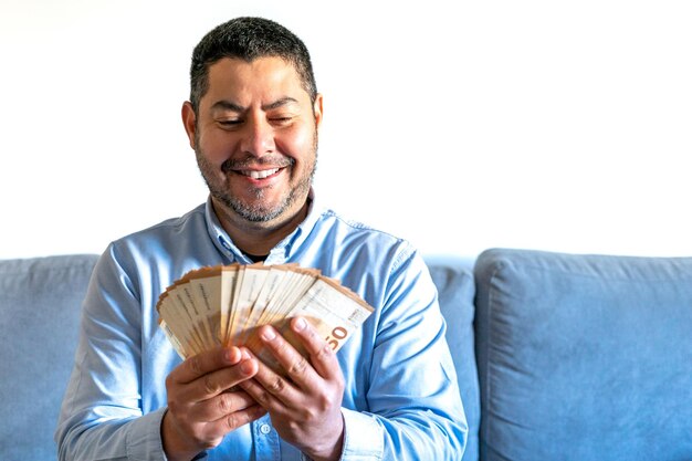 Man very happy to hold and count a lot of bills in his hands